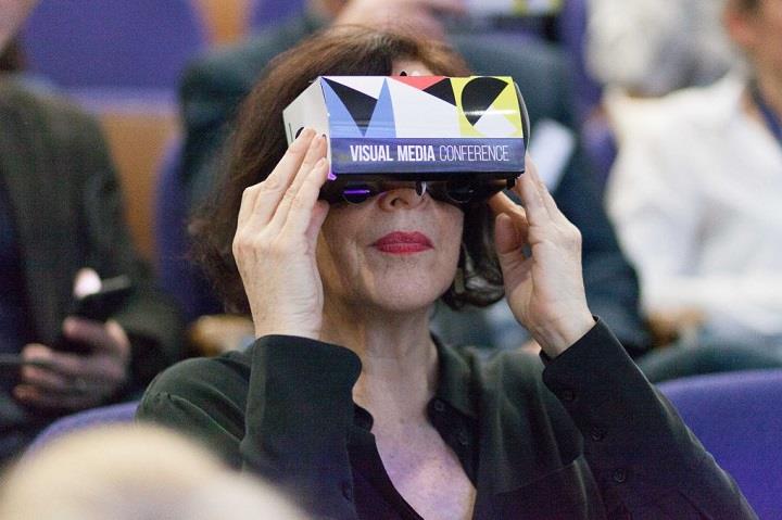 Lady in a black top wearing virtual reality glasses.