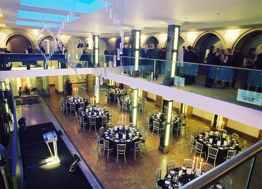 View of Banking Hall set for dinner from the mezzanine with glass balustrade.